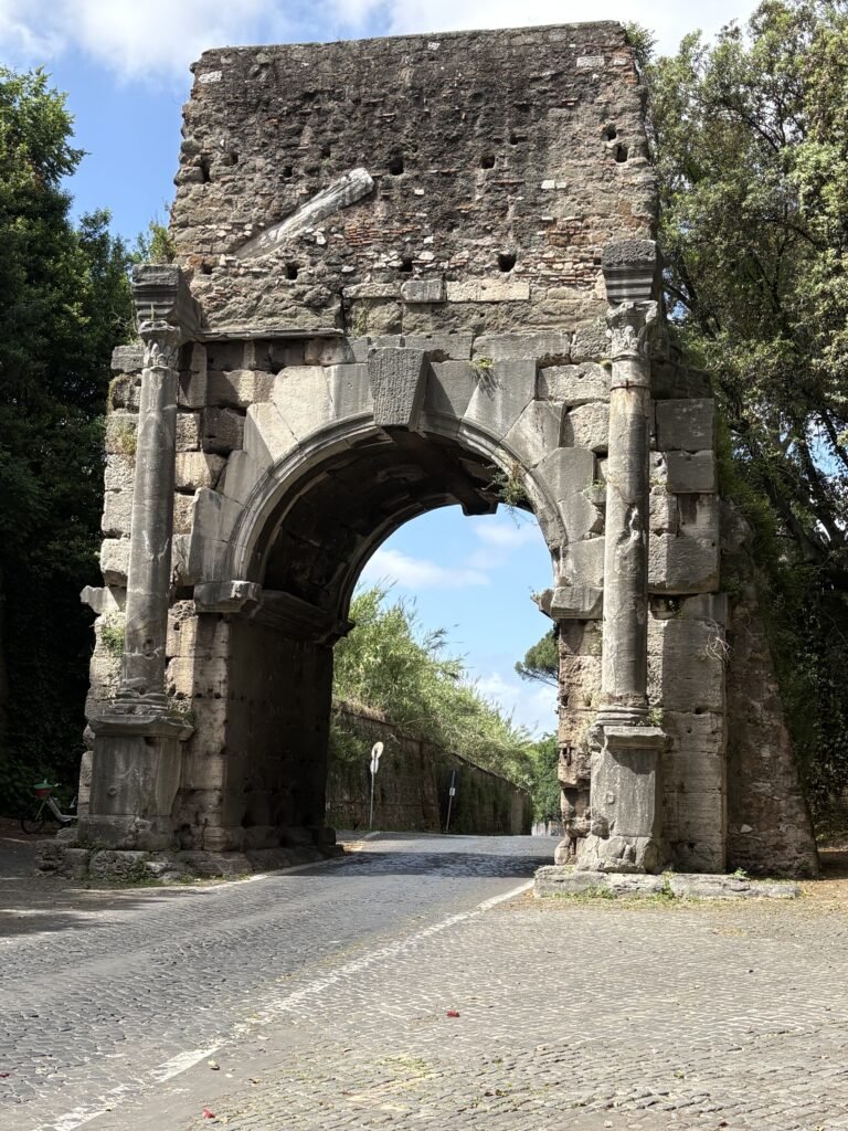 Ancient stone gateway in the Aurelian Walls along the cycling route from central Rome.