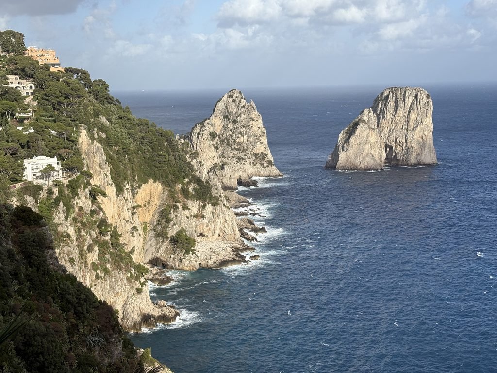 View of the Faraglioni rock formations from the Gardens of Augustus in Capri.