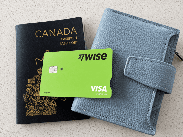 Wise travel card beside a Canadian passport and travel wallet.